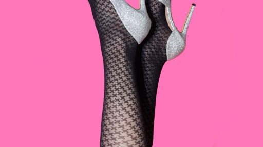 a woman's legs in fishnet stockings on a pink background